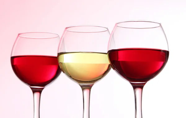 Glasses of wine on light pink tone — Stock Photo, Image