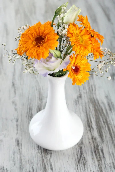 Calendula flowers in vase on wooden background — Stock Photo, Image