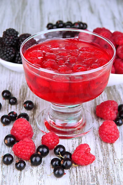 Jelly with fresh berries on wooden table close up — Stock Photo, Image