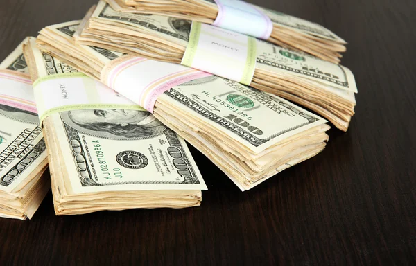 Stacks of money on wooden table — Stock Photo, Image