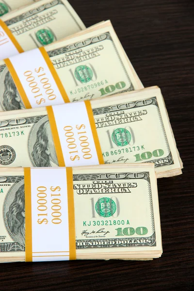 Stacks of money on wooden table — Stock Photo, Image
