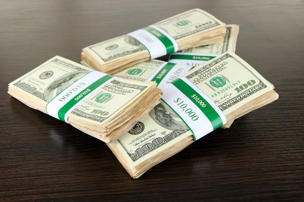 Stacks of money on wooden table — Stock Photo, Image