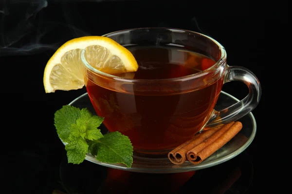 Cup of tea with lemon isolated on black