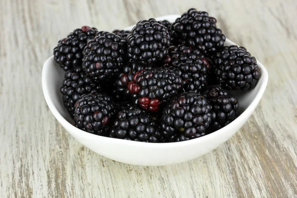Sweet blackberries in bowl on table close-up Stock Image