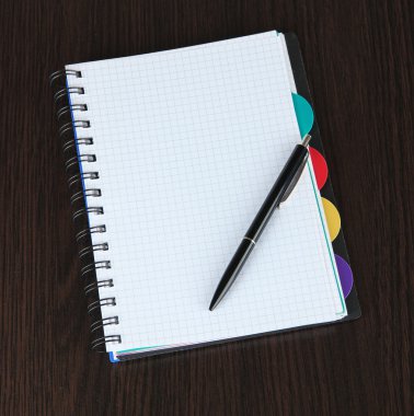 defter ve kalem ahşap masaya
