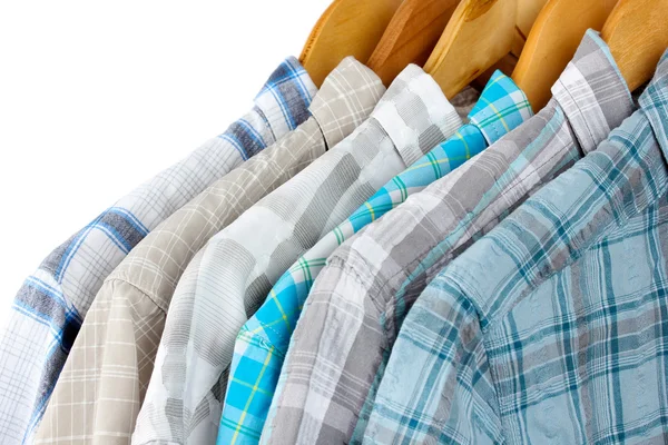 Shirts with ties on wooden hangers on light background — Stock Photo, Image