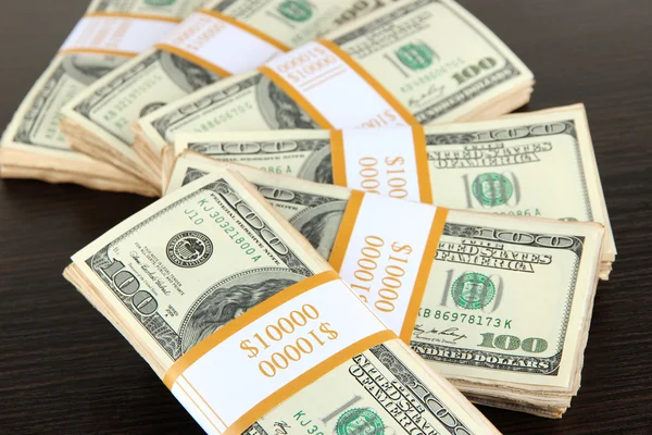 Stacks of money on wooden table — Stock Photo, Image