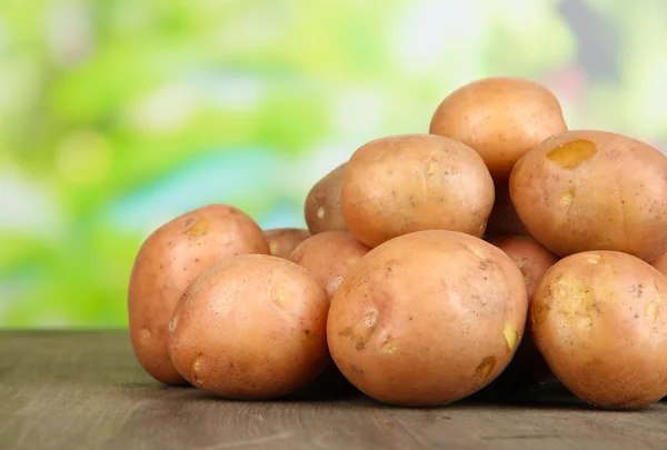 Potato on wooden table — Stock Photo, Image