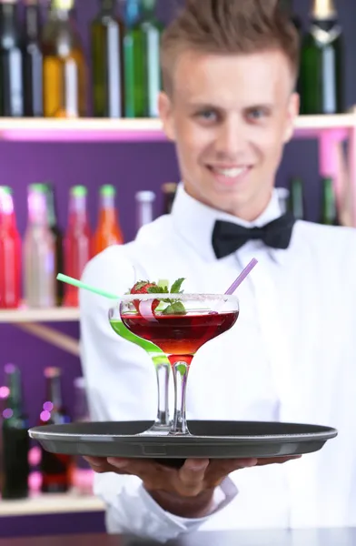 Portrait of handsome barman with different cocktails cocktail, at bar — Stock Photo, Image