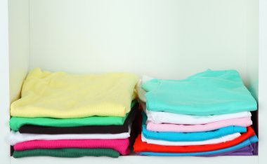 Clothes neatly folded on shelves