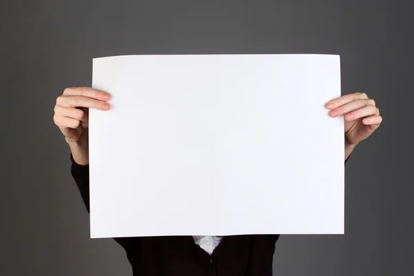 Woman holding blank sign in front her face, on color background — Stock Photo, Image