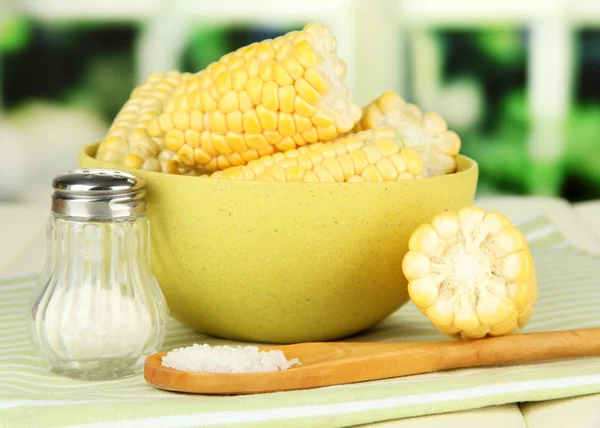 Gekochter Mais in Schüssel, auf Holztisch, auf hellem Hintergrund — Stockfoto