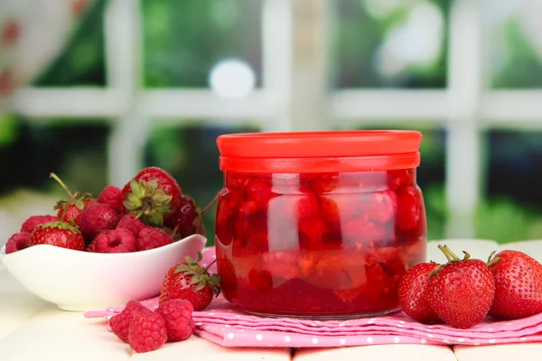 Home made berry jam on wooden table on window background — Stock Photo, Image