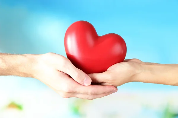 Heart in hands on cloud background — Stock Photo, Image