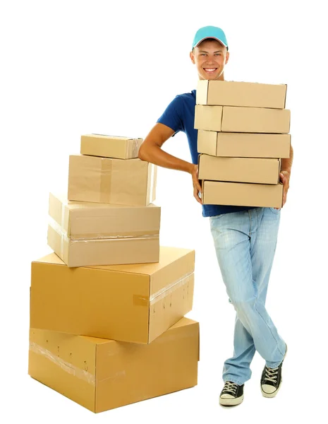 Young delivery man holding parcels, isolated on white — Stock Photo, Image