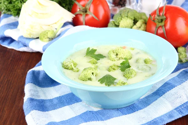 Cabbage soup in plates on napkin on wooden table — Stock Photo, Image