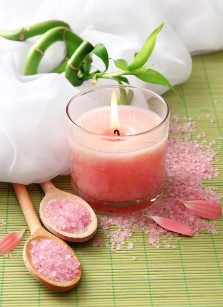 Beautiful candle on bamboo mat — Stock Photo, Image