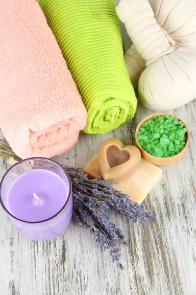 Still life with lavender candle, soap, massage balls, soap and fresh lavender, on wooden background — Stock Photo, Image