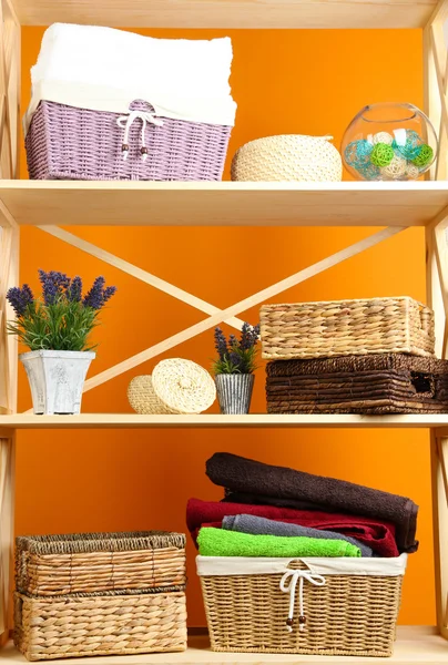 Beautiful white shelves with different home related objects, on color wall background — Stock Photo, Image