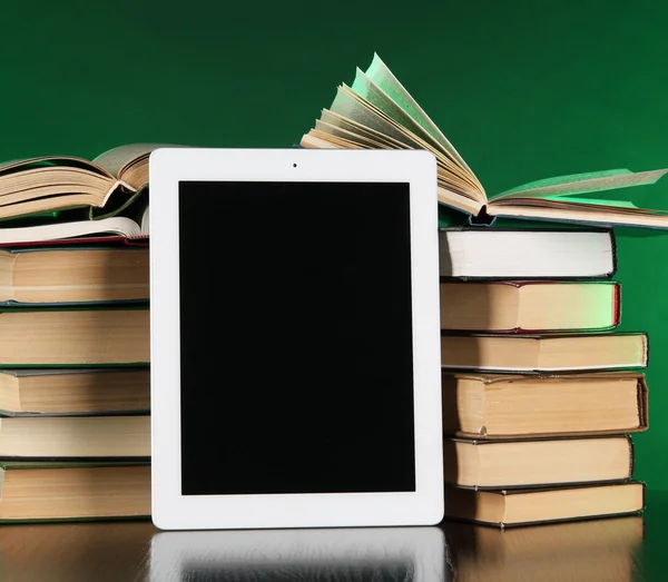 Tablet and books on bright background — Stock Photo, Image