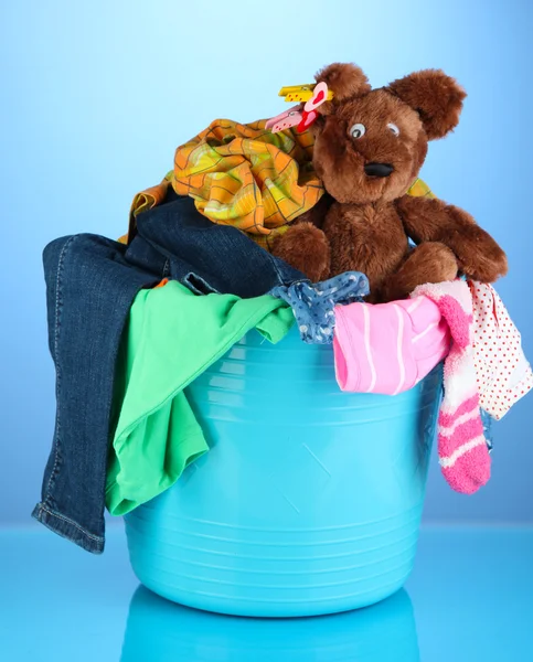 Laundry basket on blue background — Stock Photo, Image