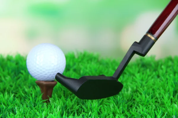 Мяч для гольфа и водитель на зеленой траве — стоковое фото