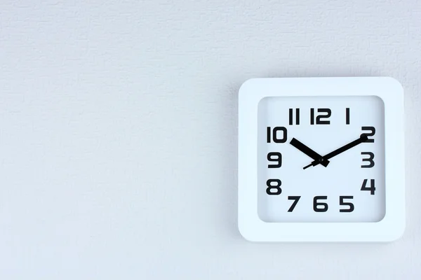 Office clock on color wall background — Stock Photo, Image