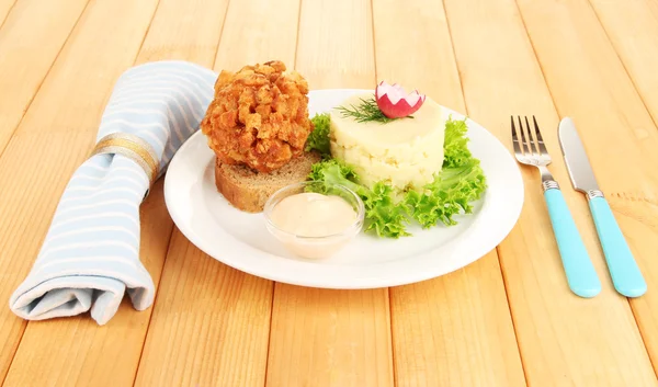Chicken Kiev on croutons with mashed potatoes, on wooden background — Stock Photo, Image