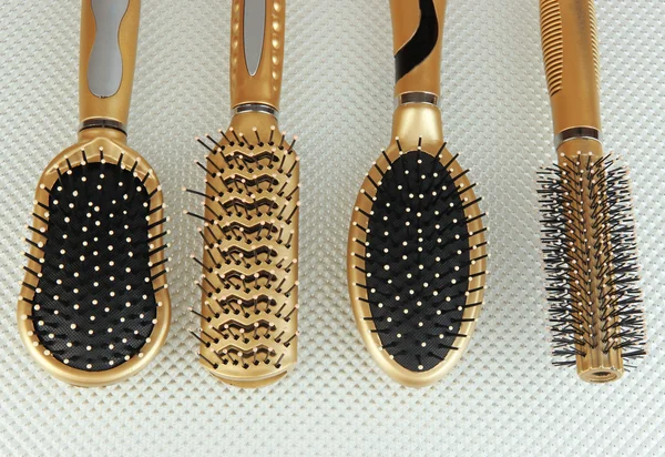 Hairbrushes on color background — Stock Photo, Image