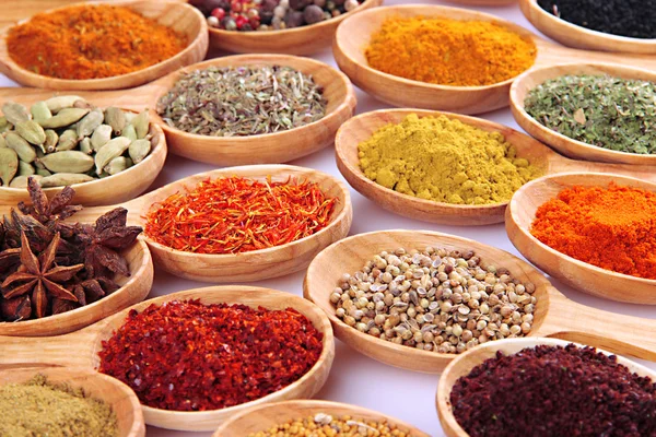 Assortment of spices in wooden spoons — Stock Photo, Image