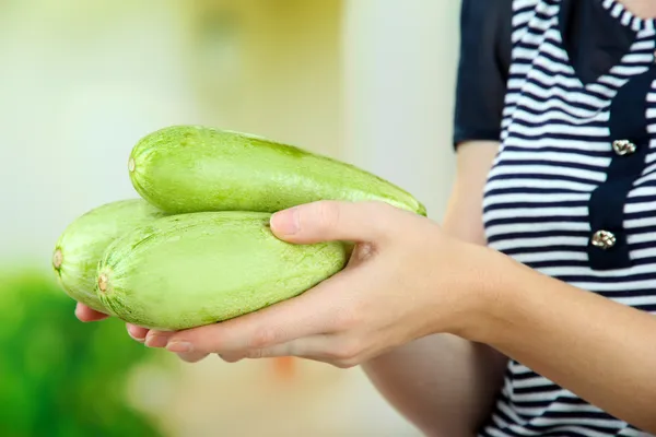 Woman hand holding raw zucchini, outdoors — Stock Photo, Image