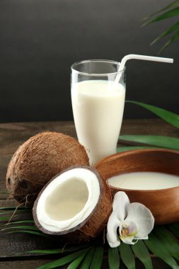 Hindistan cevizi ile süt, gri arka plan üzerinde ahşap tablo
