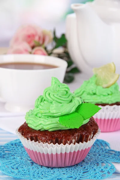 Beautiful cupcakes on dining table on room background — Stock Photo, Image