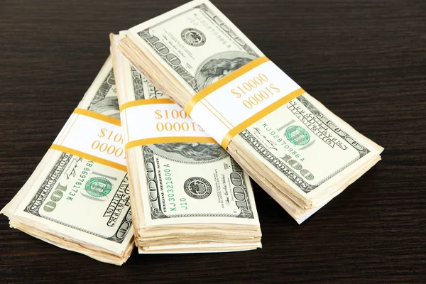 Stacks of money on wooden table — Stock Photo, Image