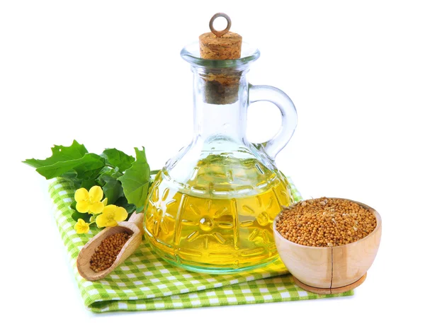 Jar of mustard oil and seeds with mustard flower on wooden background — Stock Photo, Image