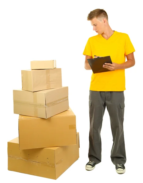 Young delivery man with parcels and clipboard, isolated on white — Stock Photo, Image