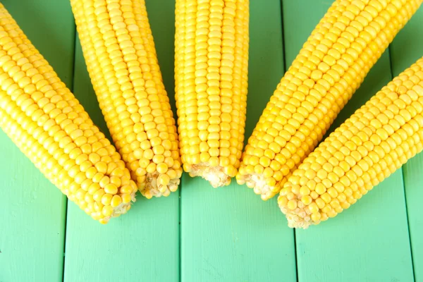 Crude corns on wooden table — Stock Photo, Image