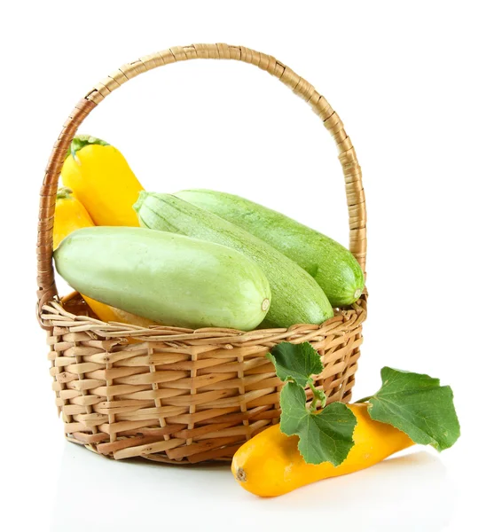 Raw yellow and green zucchini in wicker basket, isolated on white — Stock Photo, Image