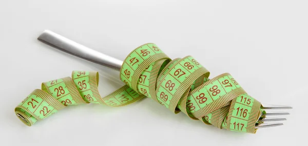 Fork tied measuring tape isolated on white — Stock Photo, Image