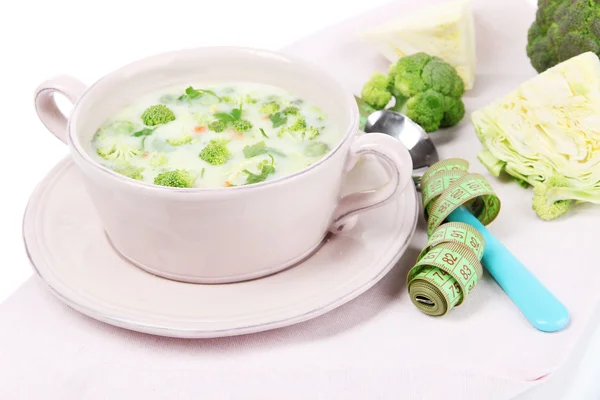 Cabbage soup in plate on napkin isolated on white — Stock Photo, Image