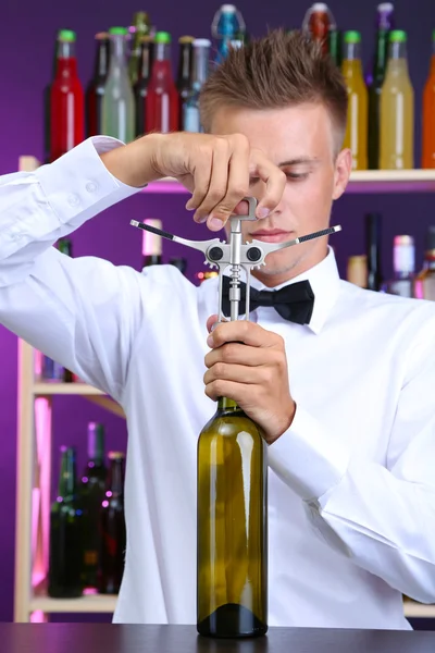Bartender opens bottle of wine — Stock Photo, Image