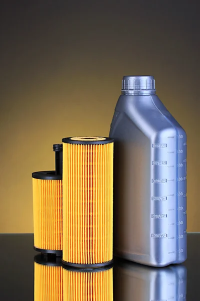 Car oil filters and motor oil can on dark color background — Stock Photo, Image