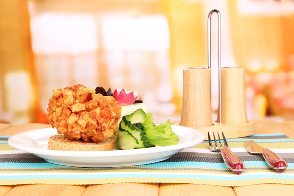 Chicken Kiev on croutons with mashed potatoes, on wooden table, on bright background — Stock Photo, Image