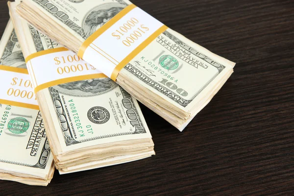 Stacks of money on wooden table Royalty Free Stock Photos