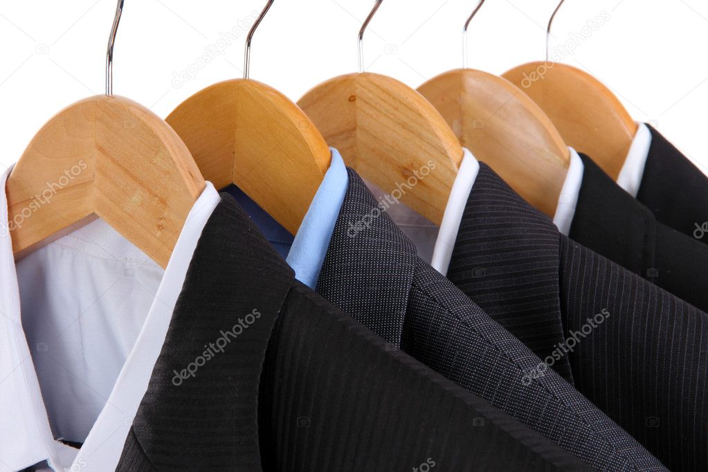 Suits with shirts on hangers on white background
