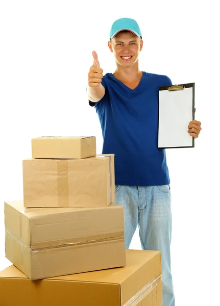 Young delivery man with parcels and clipboard, isolated on white — Stock Photo, Image