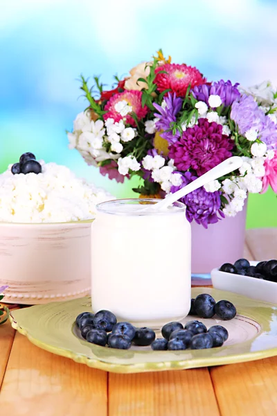 Productos lácteos frescos con arándanos en mesa de madera de cerca — Foto de Stock