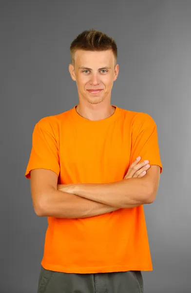 T-shirt on young man, on grey background Stock Picture