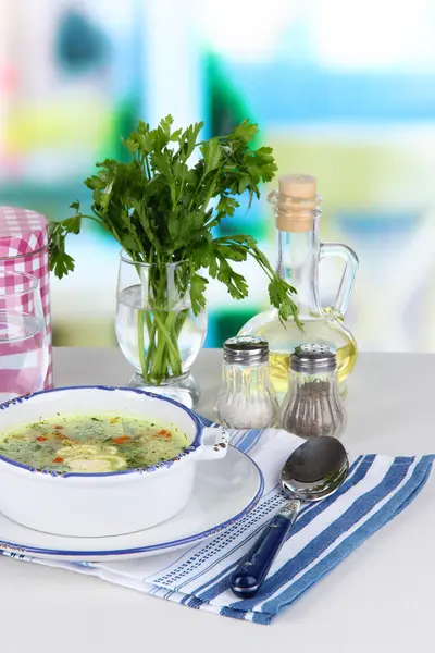 Soup in plate on napkin on table on window background — Stock Photo, Image