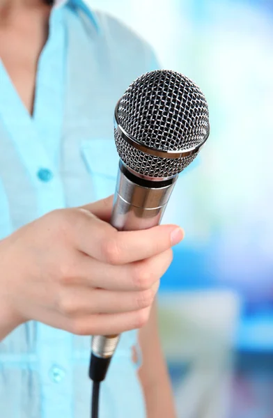 Female with microphone on room background — Stock Photo, Image